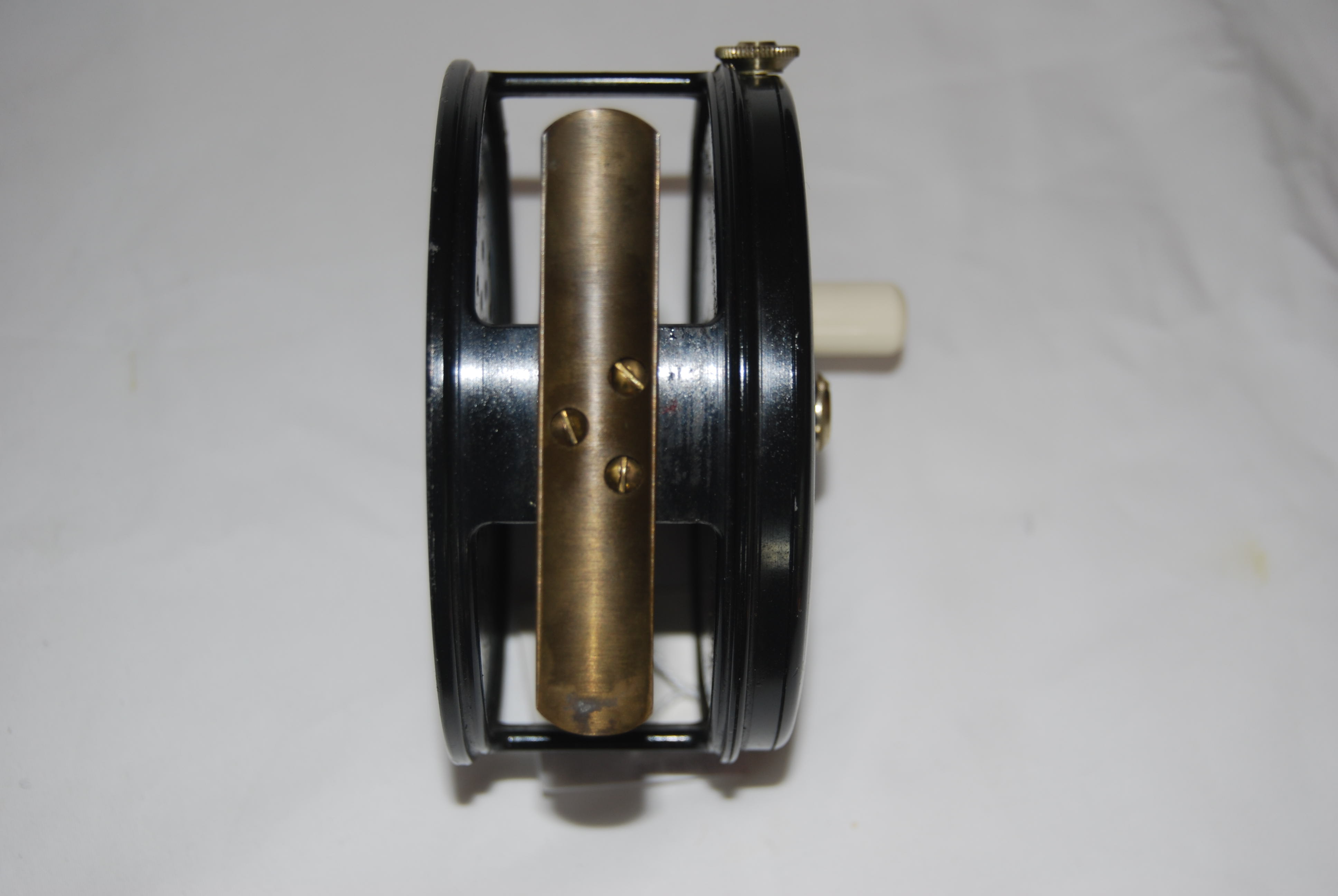 4 1/4” ALLCOCKS [JW YOUNG] “PERFECT-TYPE” SALMON REEL. No Line Guard. RHW.  Long smooth brass foot fastened with 3 screws [3 1/4]; Adjustable Dual  Check Mechanism; Ball-bearing Race; White Xylonite Knob; Totally