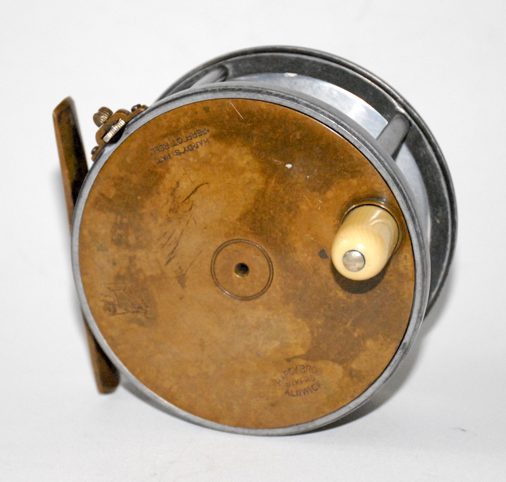 A very rare Hardy Perfect 4 ½ salmon fly reel with inset nickel silver  spindle medallion, reel with domed ivorine handle, pierced brass foot,  fixed nickel silver line guide, strapped rim tension