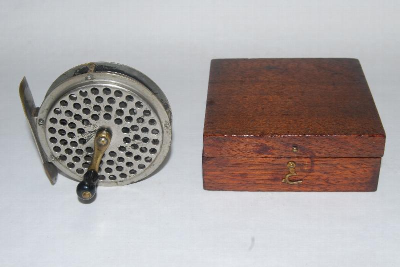 2 7/8 ORVIS PATENT 1874 Fly Reel. RHW. 4 1/2 oz. 2nd Model with riveted  construction. Tail plate cap marked: C.F.Orvis Manchester, VT – Patented  May 12th, 1874. Original screw-on handle; in original walnut box